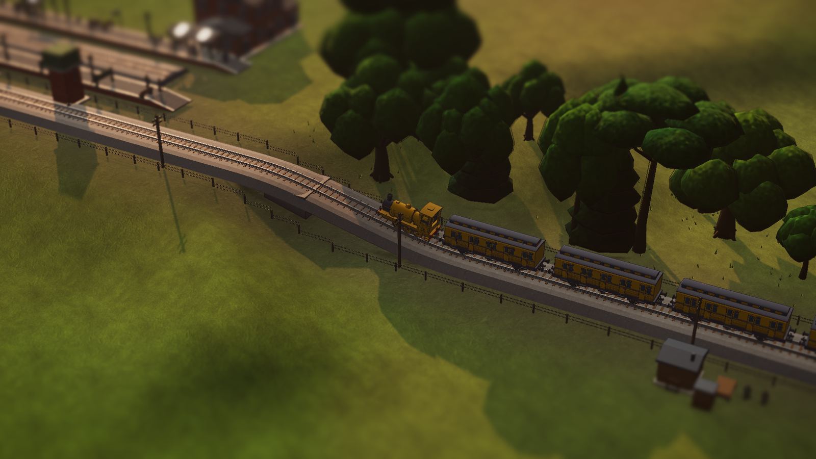 A passenger train on an embankment in late light.
