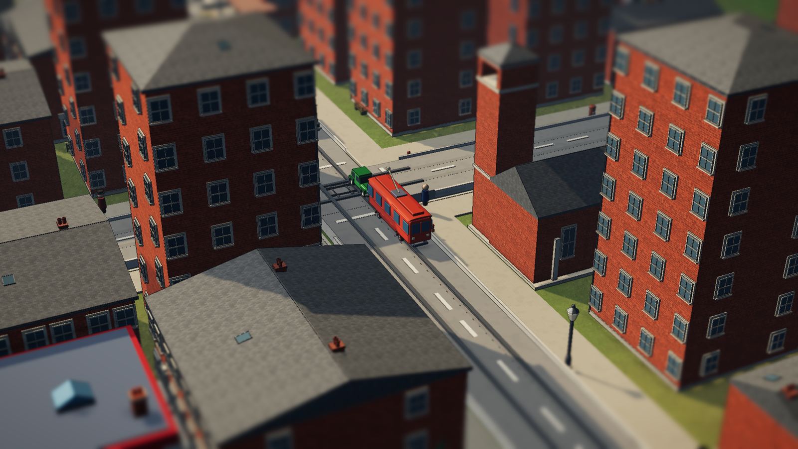 A red tram crossing a street between brick blocks.