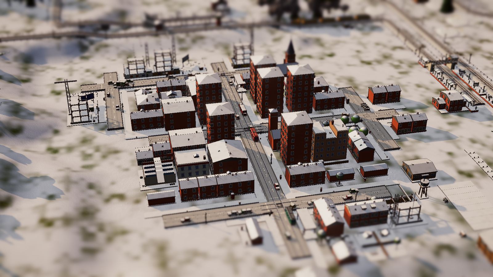 A town under snow, its streets and rail yards white.